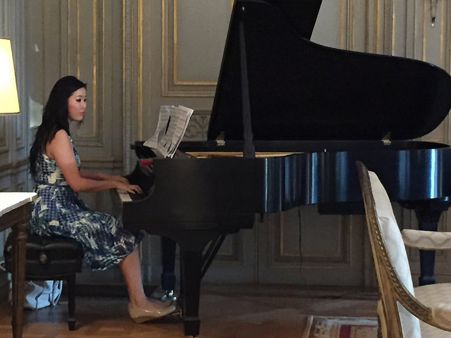 IFE Fellow Joanne Ke entertains guests with her musical talents on piano
